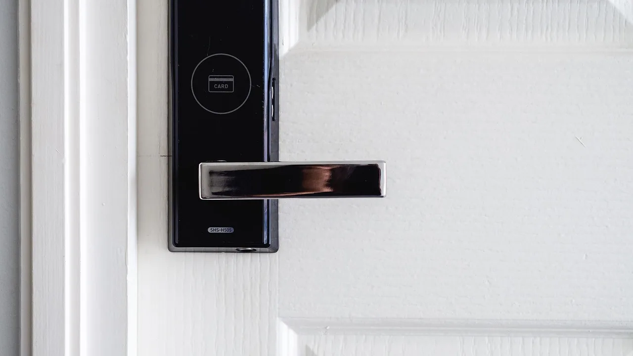 Apartment entry door with deadbolt and reinforced strike plate being inspected by a locksmith